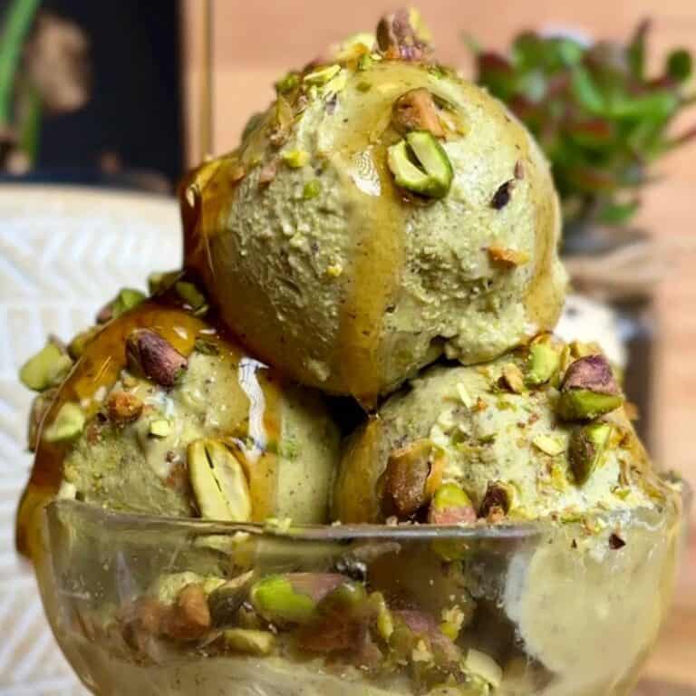 3-ingredient pistachio ice cream with crushed pistachios and maple syrup drizzle