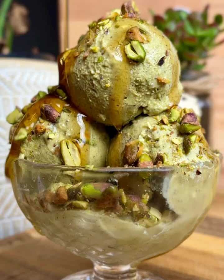3-ingredient pistachio ice cream sundae with chopped pistachio and maple syrup drizlle