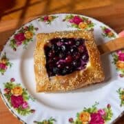blueberry ricotta rice paper danish with jammy blueberry center and sesame seed topping