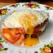 chicken parm potato breakfast waffles topped with a runny egg and parmesan