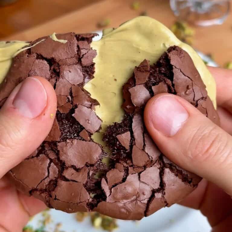 crispy crackly chewy pistachio brownie cookie with pistachio butter in the middle