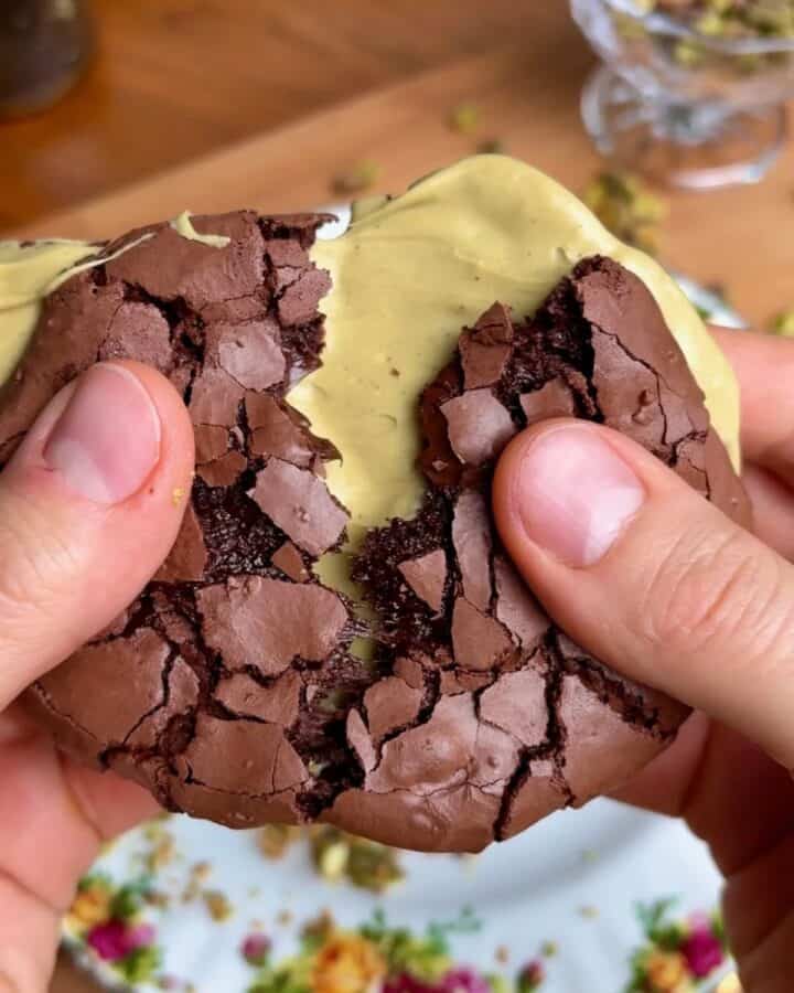crispy crackly chewy pistachio brownie cookie with crispy chocolate top and pistachio butter in the middle