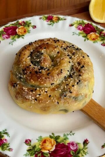 East meets west spanakopita rice paper spiral with white and black sesame seeds