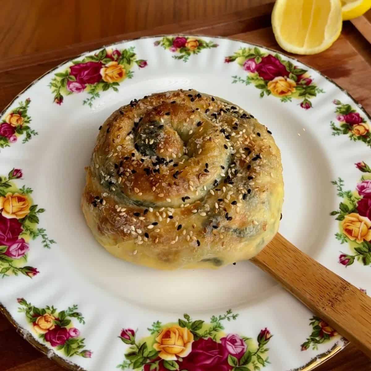 East meets west spanakopita rice paper spiral with white and black sesame seeds