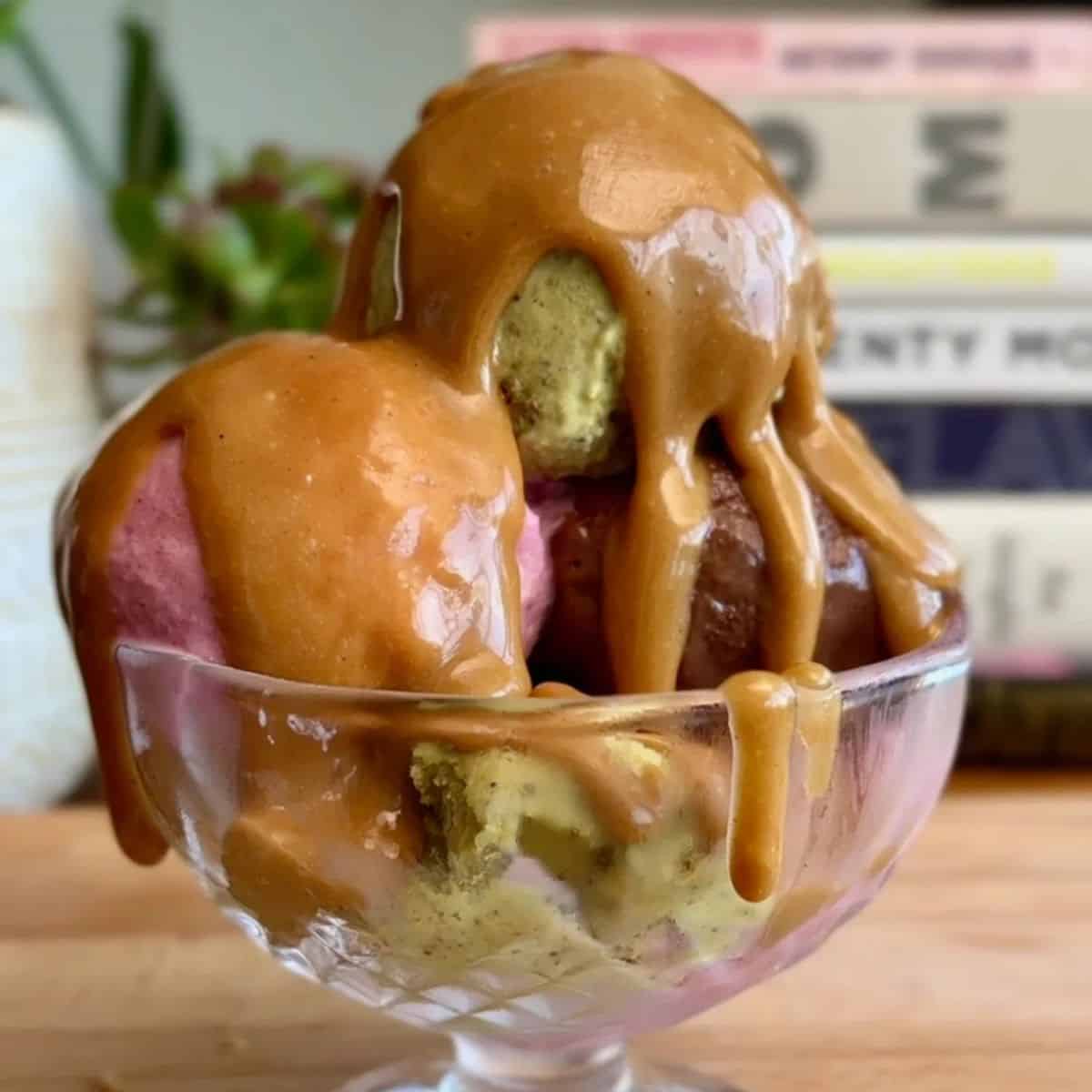 easy 2 ingredient caramel sauce drizzled on a tri-color sundae