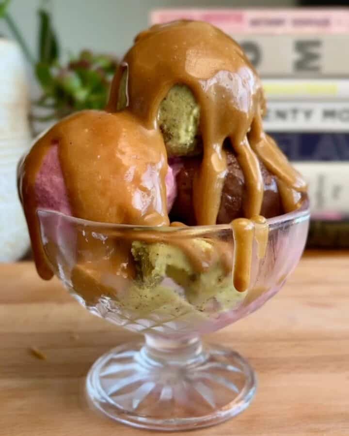 easy 2 ingredient caramel sauce drizzled over a Neapolitan ice cream sundae