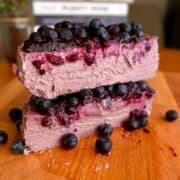 fudgy high protein blueberry cheesecake with jammy fresh blueberry topping