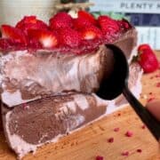 fudgy high protein dark chocolate strawberry cheesecake with creamy middle and chopped strawberries
