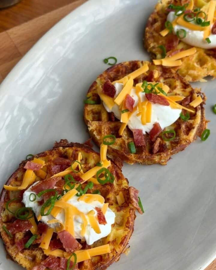 fully loaded baked potato waffles topped with green onion, bacon, yogurt and cheese