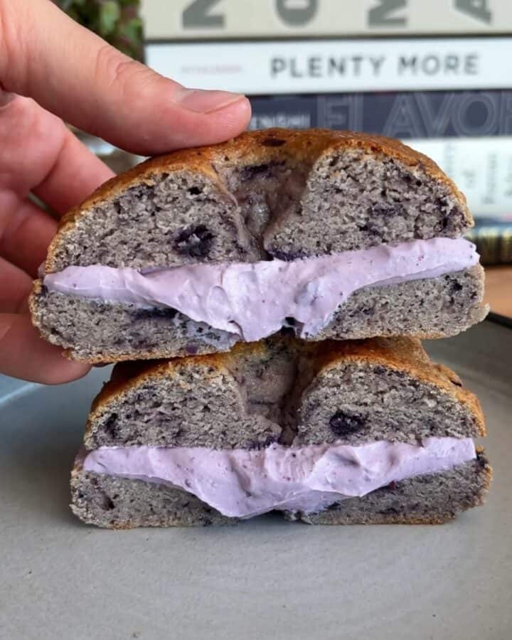 high protein blueberry bagel sandwich with blueberry cream cheese in the middle