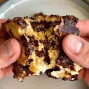high protein cream cheese stuffed brookie bar with melted chocolate chips in the middle