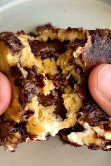 high protein cream cheese stuffed brookie bar with melted chocolate chips in the middle