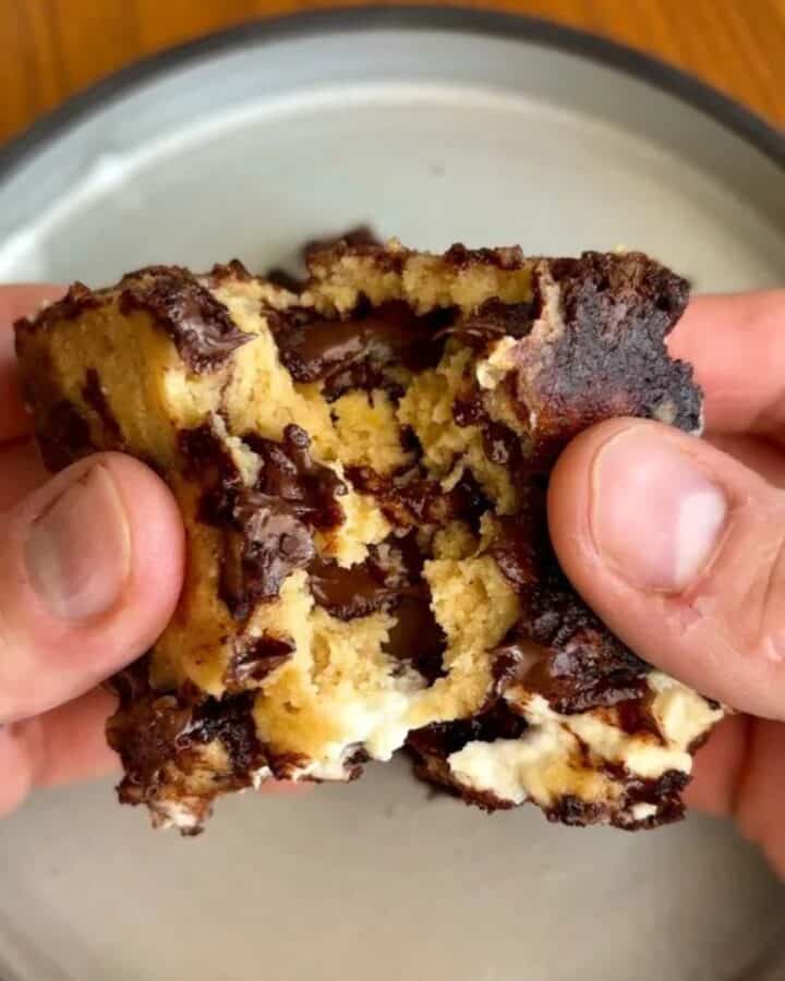 high protein cream cheese stuffed brookie bar with melted chocolate and cream cheese in the center