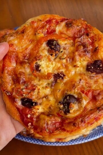 high protein mini greek pizza with olives and red pepper flakes