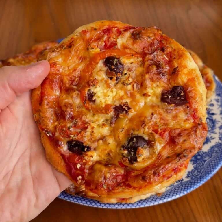 high protein mini greek pizza with olives and red pepper flakes