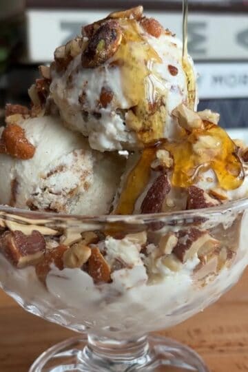 high protein peanut butter praline ice cream sundae with a maple syrup drizzle