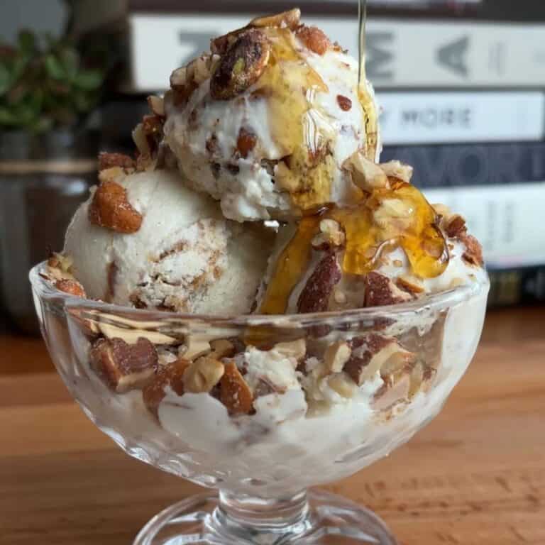 high protein peanut butter praline ice cream sundae with a maple syrup drizzle