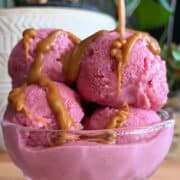 high protein strawberry ice cream sundae with caramel sauce drizzle