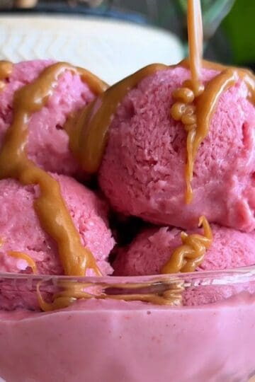 high protein strawberry ice cream sundae with caramel sauce drizzle