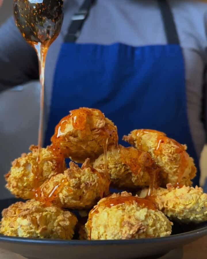 plate of hot honey cornflake chicken, coated in hot honey drizzle