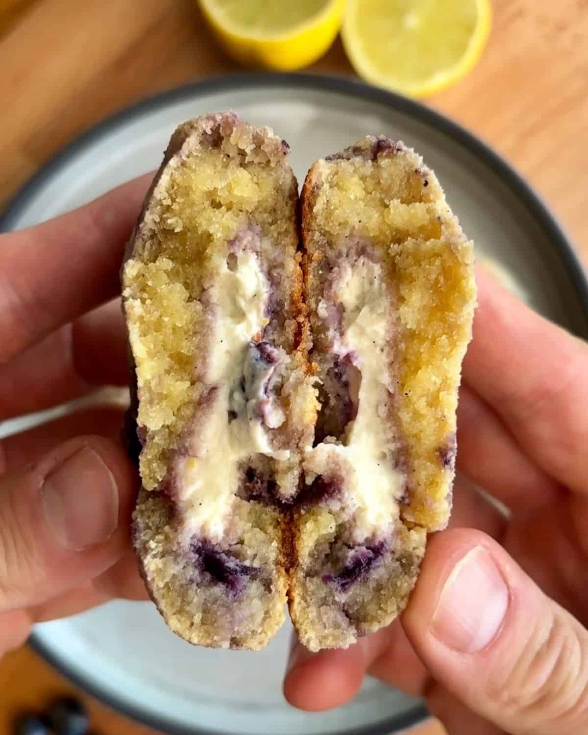 Inside of lemon blueberry cheesecake cookie with cheesy cheesecake filling