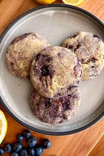 Lemon blueberry cheesecake cookies with fresh blueberries and lemon slices