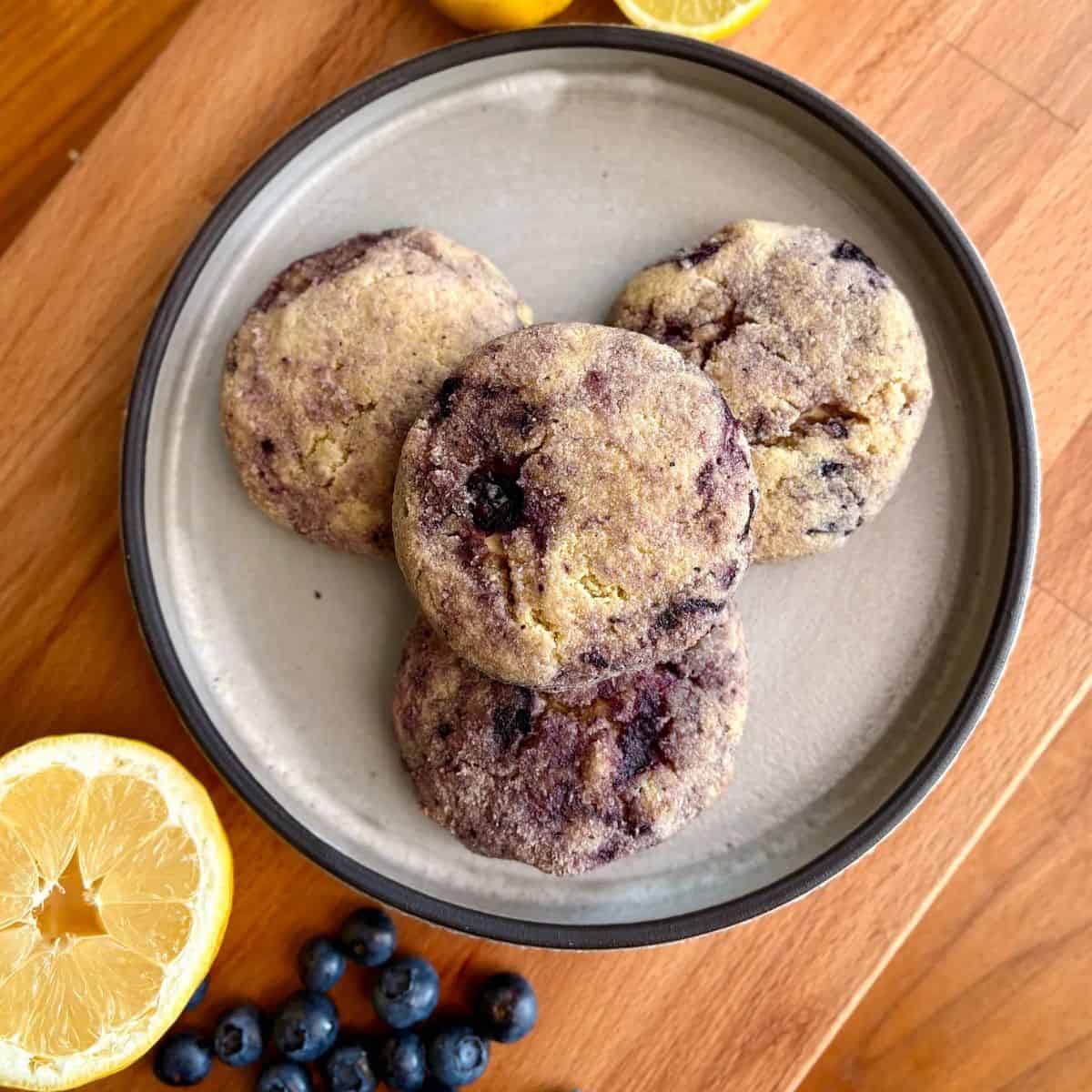 Lemon blueberry cheesecake cookies with fresh blueberries and lemon slices