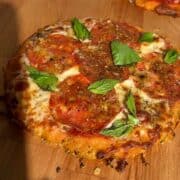 Pepperoni hot honey pizza with sweet potato crust, red pepper flakes and fresh basil