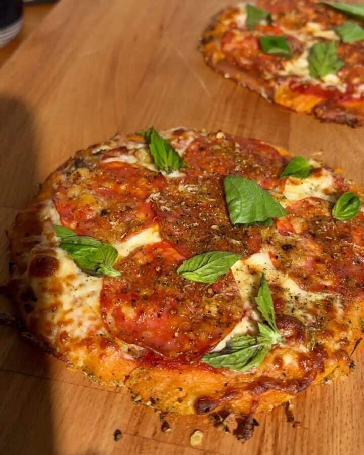 Pepperoni hot honey pizza with sweet potato crust, topped with melted cheese, crushed red pepper flakes and fresh basil