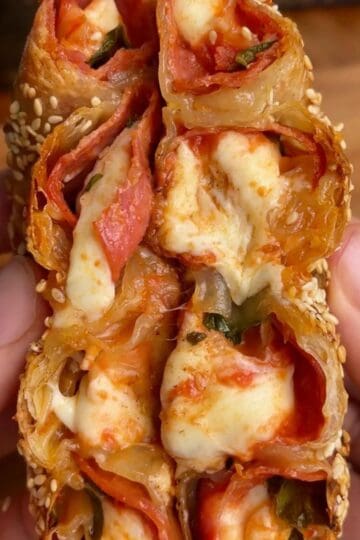pepperoni pizza rice paper spiral with melted cheese and sesame seeds