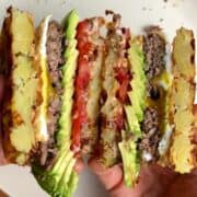 potato waffle breakfast burger with egg, beef, avocado, cheese, and tomato