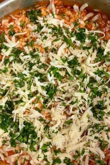 30 minute one pan lasagna ready for the oven with fresh tomato sauce, fresh mozzarella, and fresh parsley on top