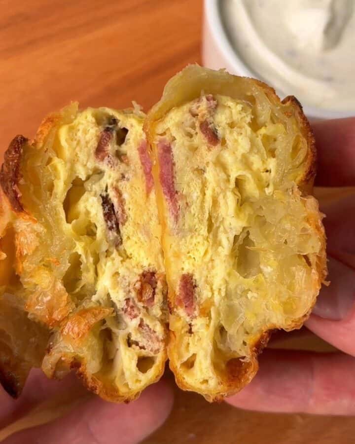 a sliced bacon, egg and cheese rice paper dumpling with melty cheese and crispy bacon inside