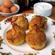 a plate of fresh, crispy, bacon, egg and cheese rice paper dumplings with a side of garlic dip