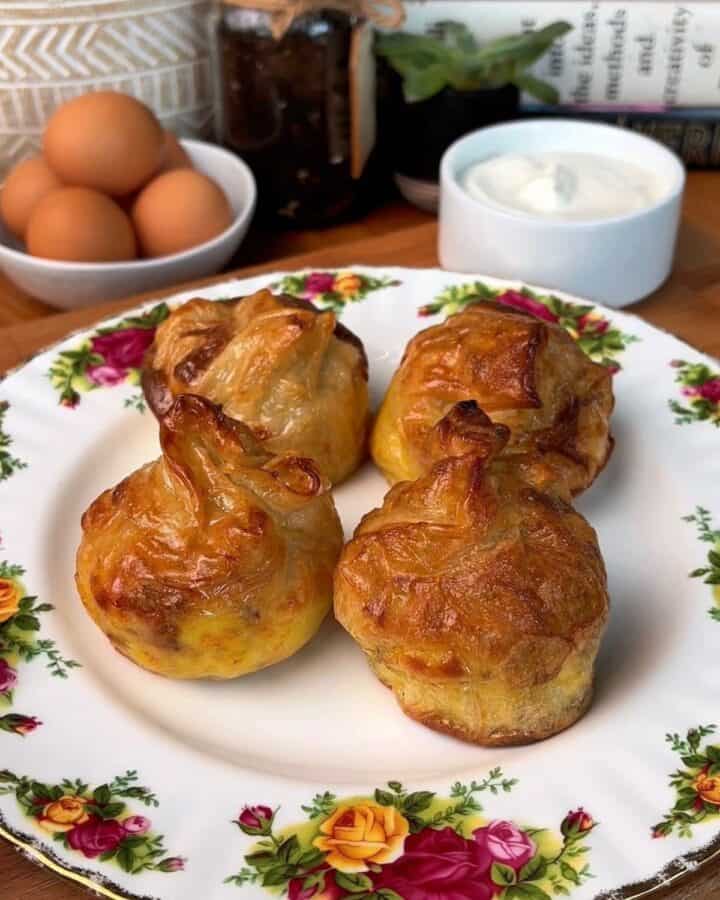 a plate of crispy bacon, egg and cheese rice paper dumplings with a side of garlicky dijon yogurt mayo dip