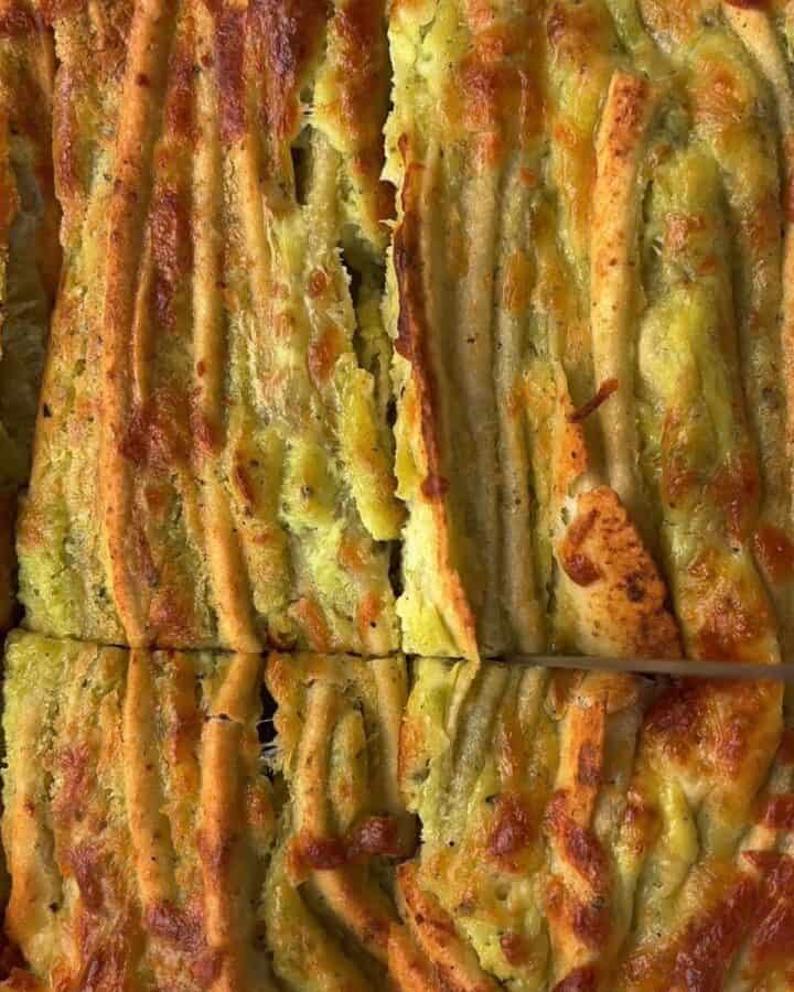 crispy, cheesy, garlic & herb tortilla pull apart bread in a pan, fresh out of the oven