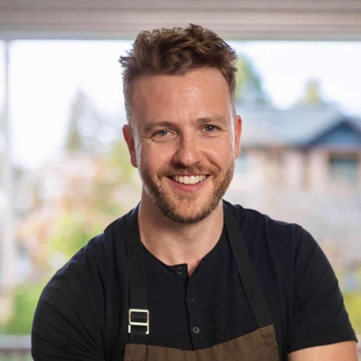professional chef, josh gale, standing in front of an open door way wearing an apron