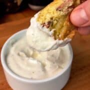 creamy garlic dijon yogurt sauce spread on a bite of a bacon, egg and cheese rice paper dumpling