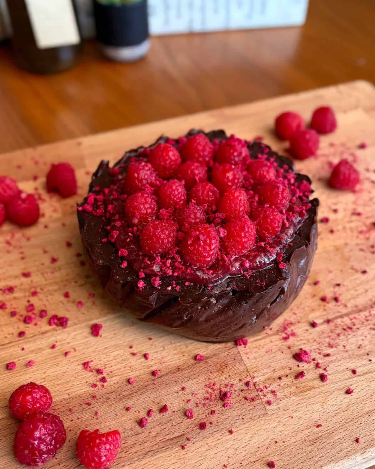fudgy high protein dark chocolate raspberry topped with freeze dried raspberries and fresh raspberries