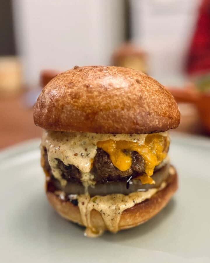 a thick American-style burger with melty cheddar cheese, punchy burger sauce and a toasted brioche bun
