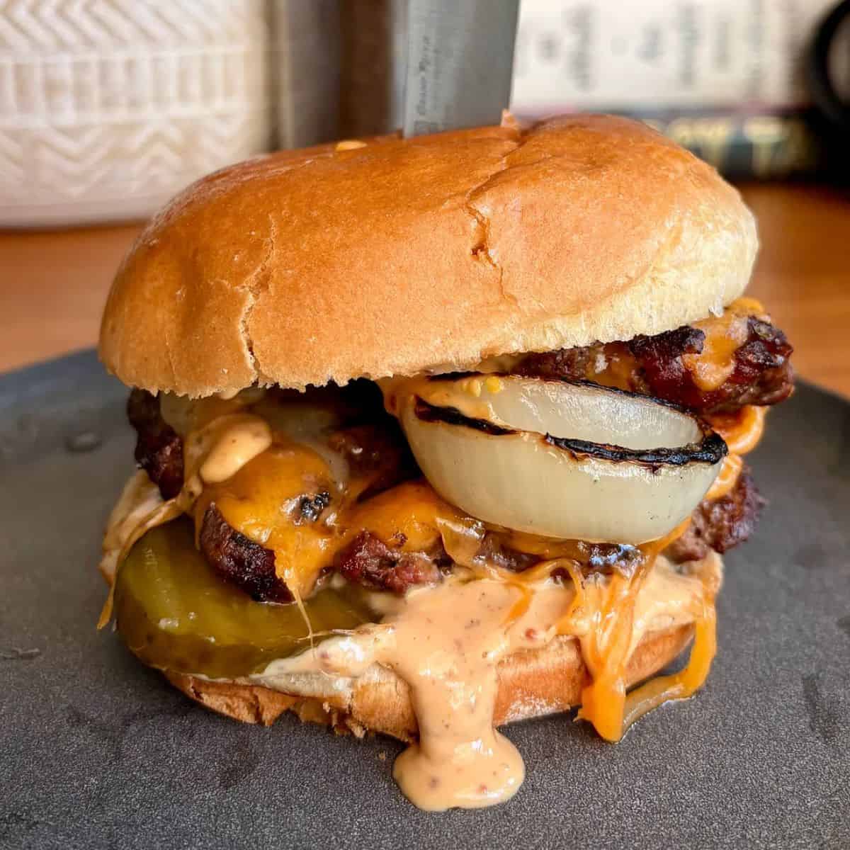 crispy, juicy, french onion style burger with melty cheddar cheese, punchy burger sauce and a toasted brioche bun