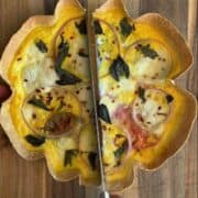 tomato burrata and herb tortilla quiche being cut in half
