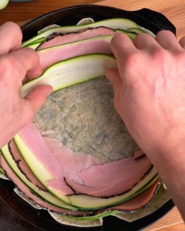 assembly of crispy zucchini and ham tortilla quiche, layering zucchini and ham into a tortilla