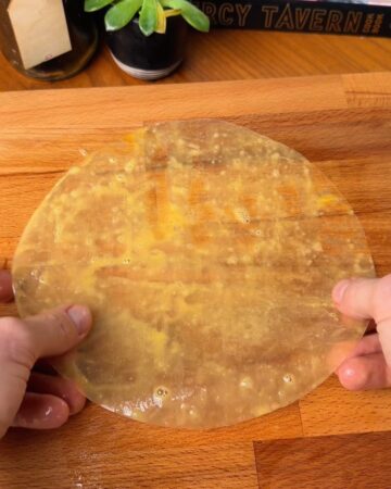 rice paper sheet dipped in egg wash in prep for bacon egg and cheese rice paper bagel