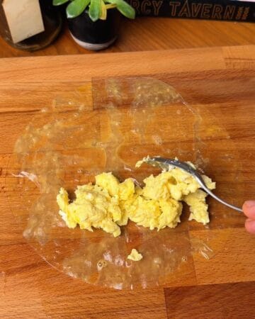 egg on a rice paper sheet in prep for bacon egg and cheese rice paper bagel