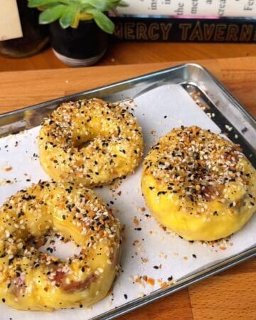 Bacon, egg and cheese rice paper bagel prepped to go in the oven