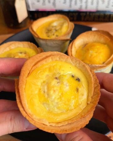 a finished, bacon, egg and cheese tortilla muffin fresh out of the oven with crispy, golden brown edges and an egg center