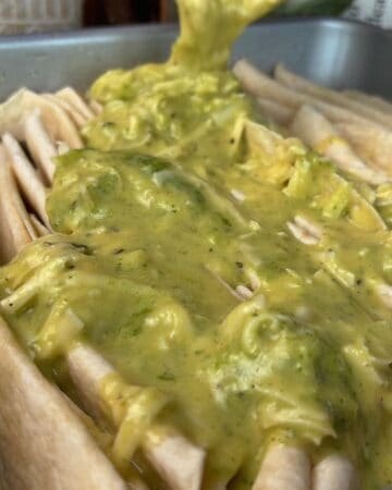 cheesy garlic mixture being poured into tortilla folds for pull-apart bread
