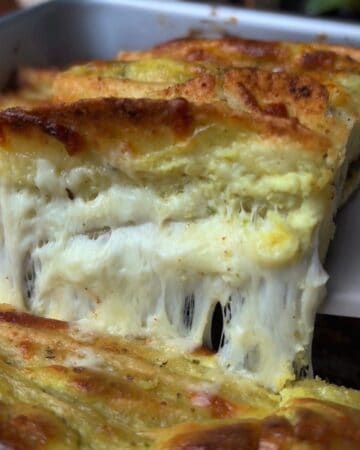 cheesy garlic and herb tortilla bread being pulled apart, fresh out of the oven