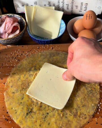 cheese being laid on rice paper in prep for the making of a crispy rice paper croque madame